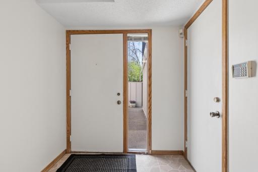 Spacious entry breezeway, side service door to garage.