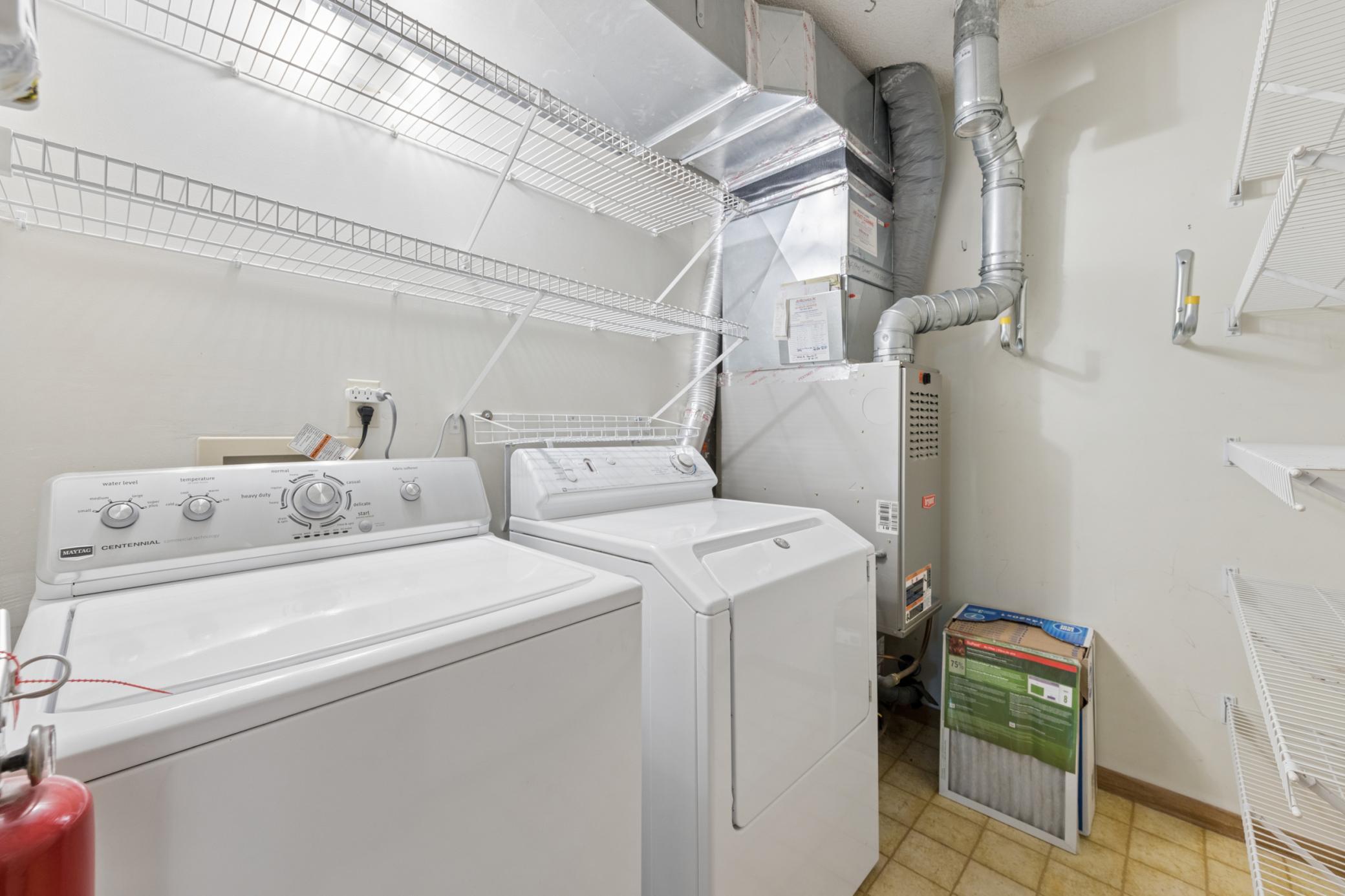 Laundry room with newer washer & gas dryer, additional storage space.
