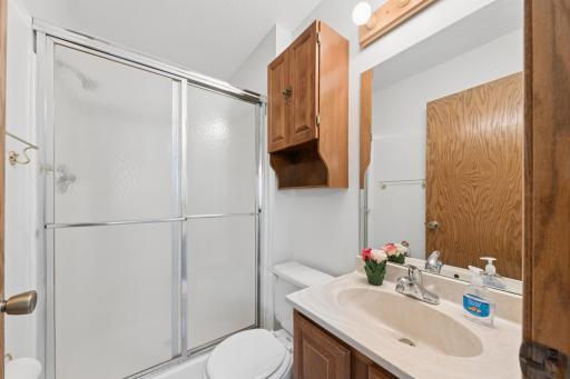 Owner suite 3/4 bathroom with solid surface counters.