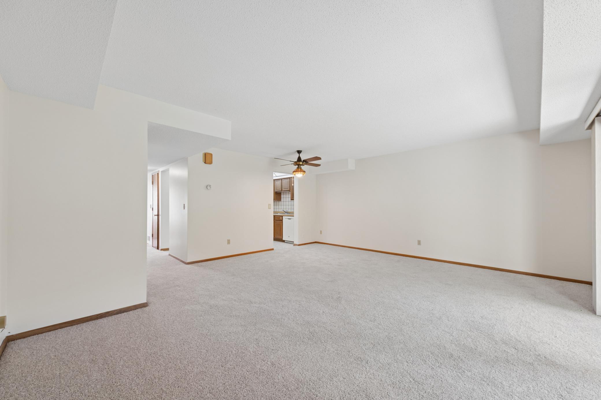 New carpet & paint throughout (2026), open concept living room & dining room space. Lots of natural sunlight, walkout level through oversized sliding glass door to backyard. Personal landscaping touches and bird feeders in back.