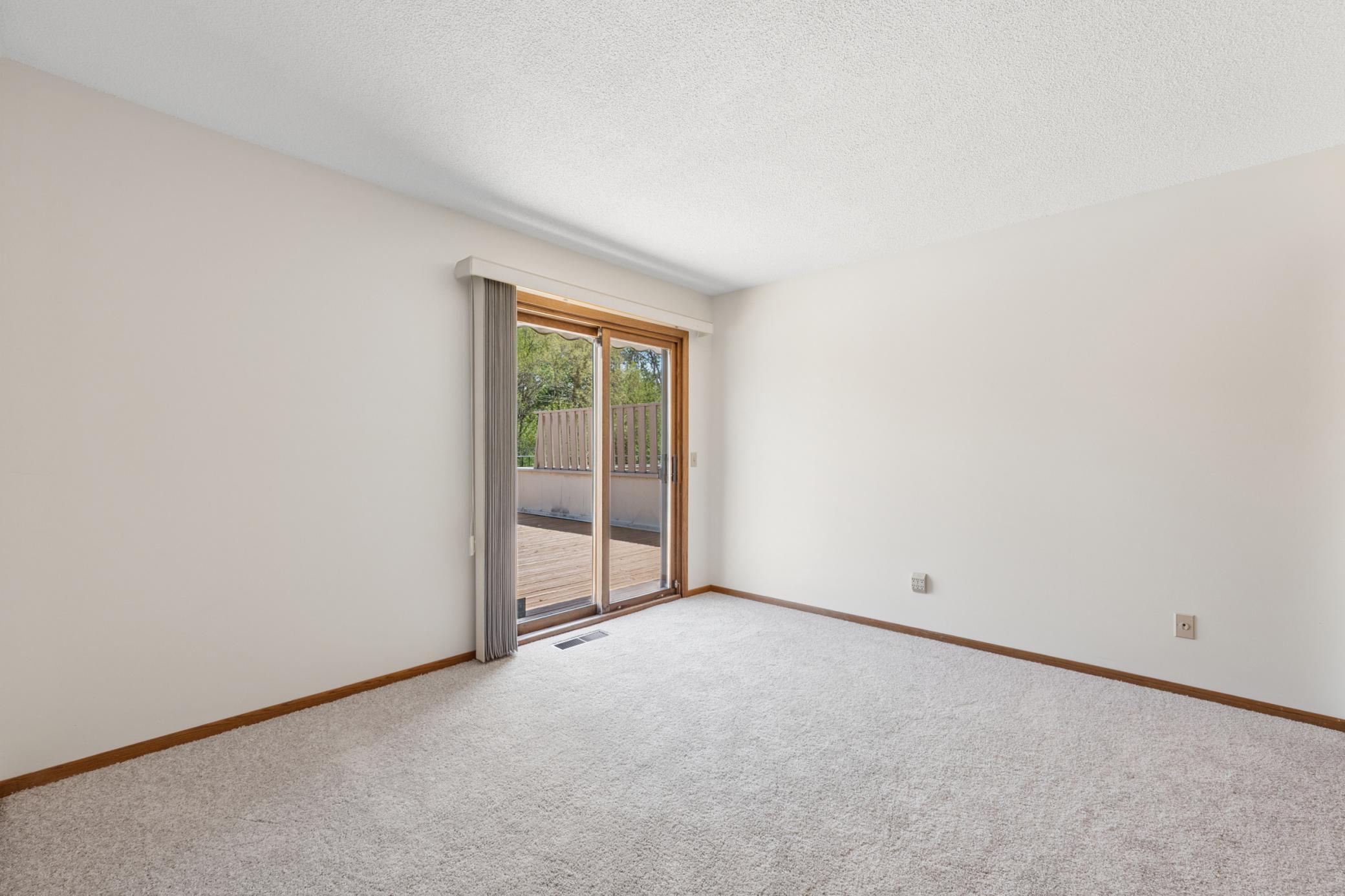 Secondary bedroom with sliding glass door leading out to large deck (21x19.4)