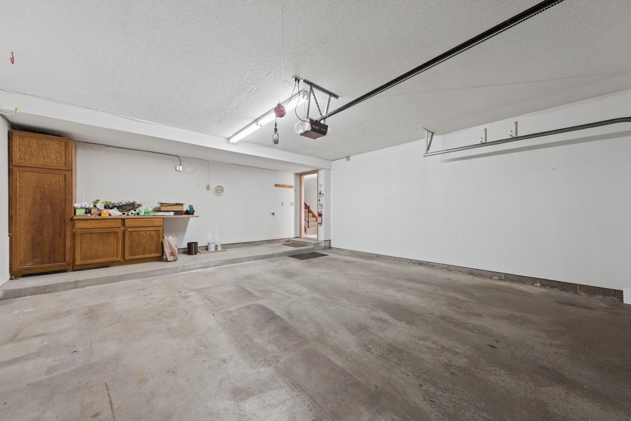 Clean, finished & painted 2 car garage, service door leading to interior entryway.