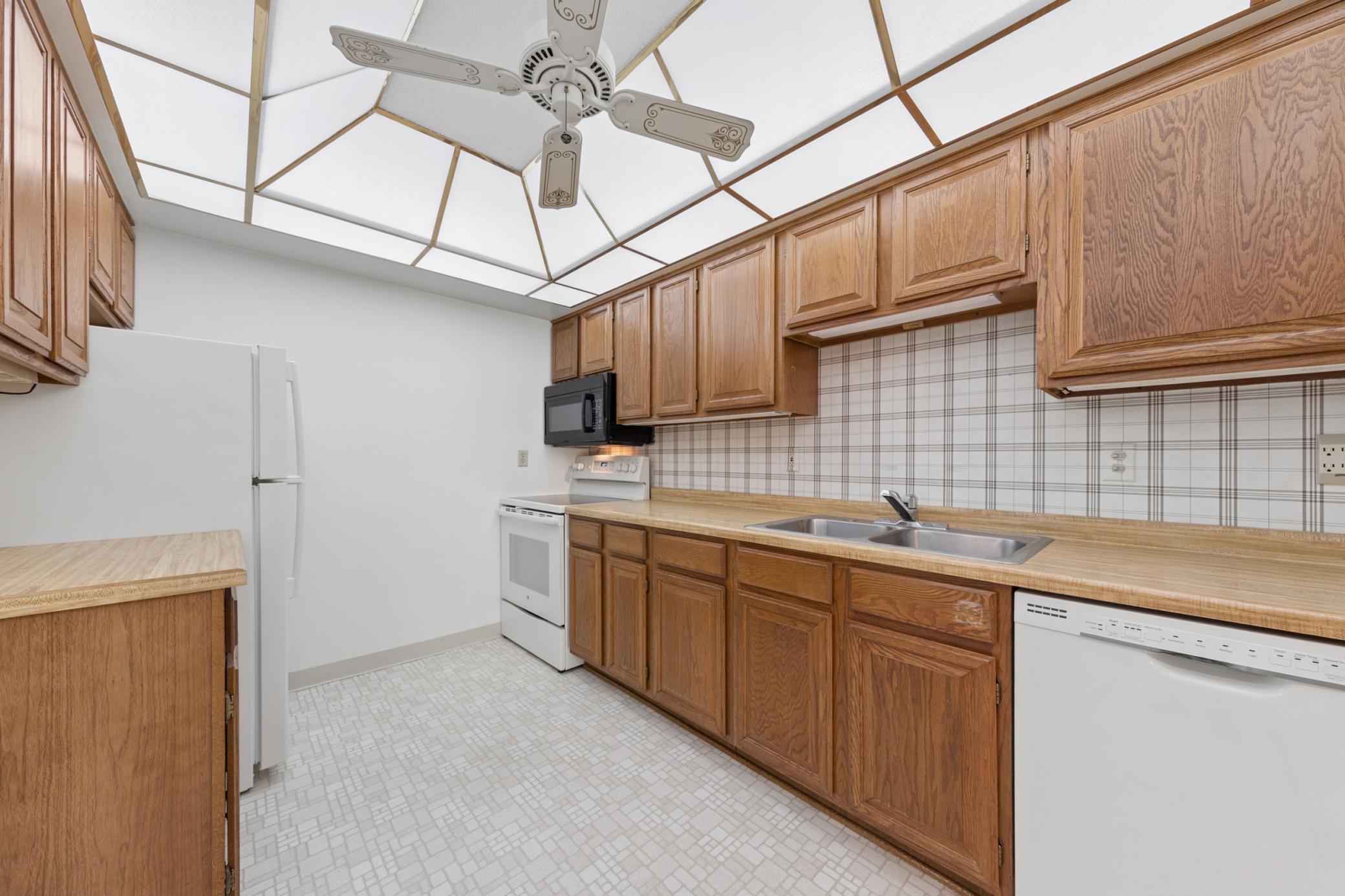 Spacious kitchen with natural wood cabinets, informal eat in kitchen space.