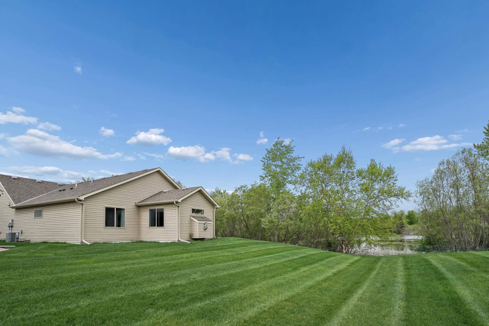 Back of home borders pond and wooded setting