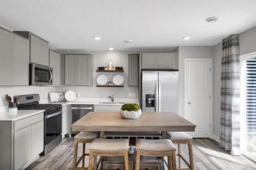 The open floor plan creates a space that seamlessly flows from kitchen and living space to your private outdoor living area. (Model photo, colors may vary)
