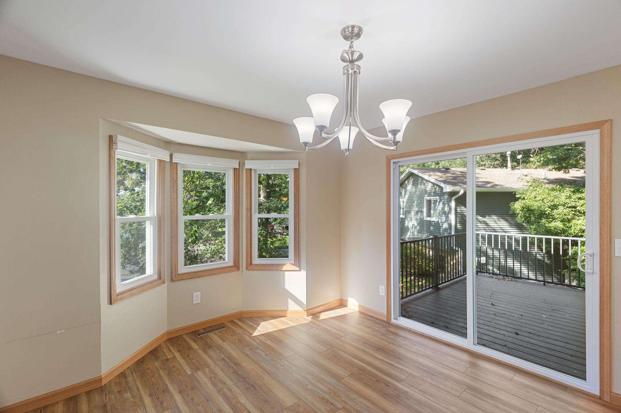 The dining space features ample, large windows and sliding door out to the deck.
