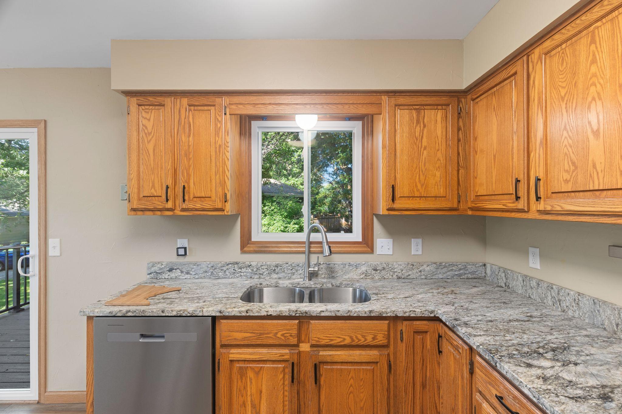 The kitchen window overlooks the deck and into the backyard.