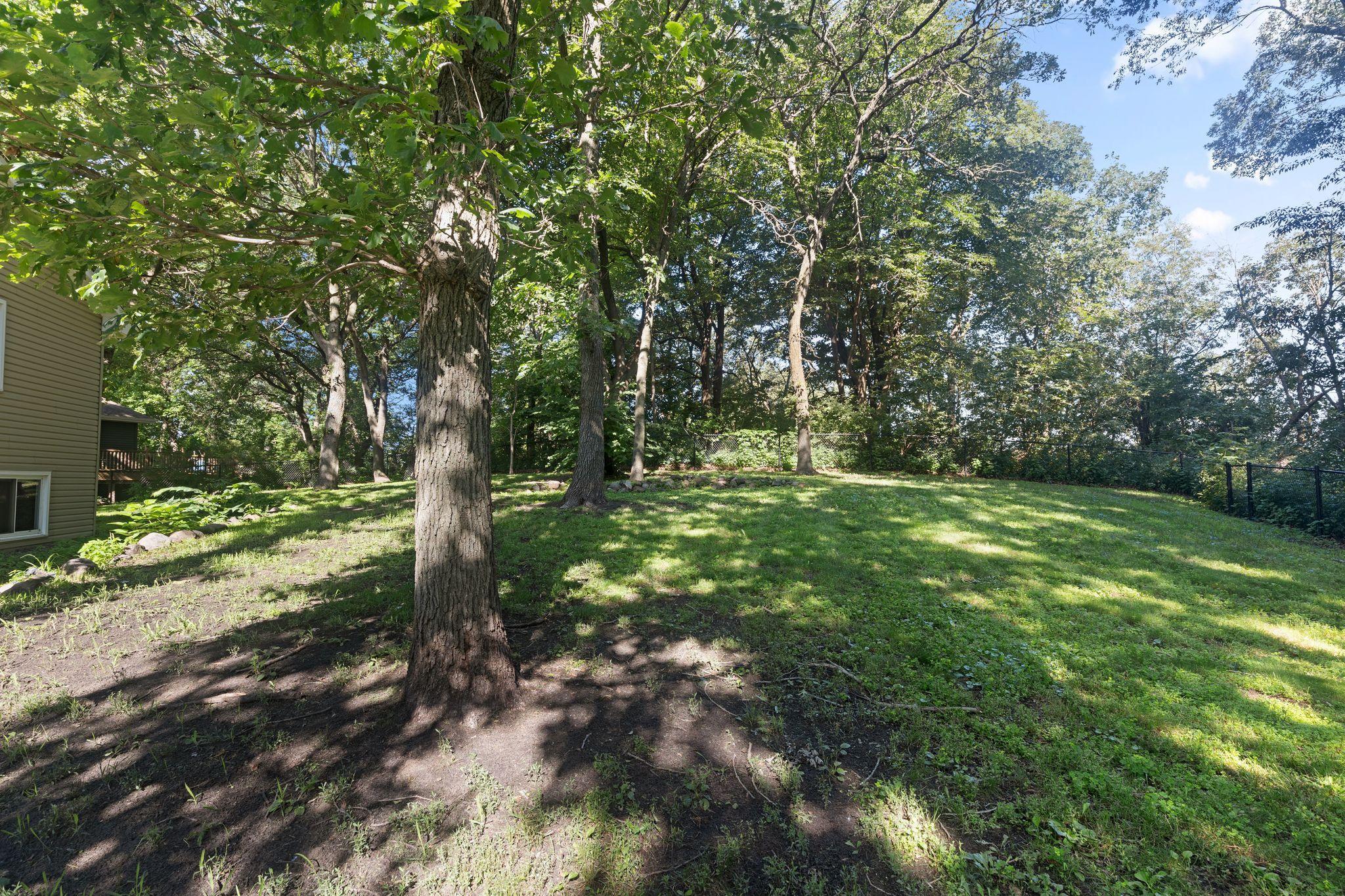 Mature trees provide shade and privacy.