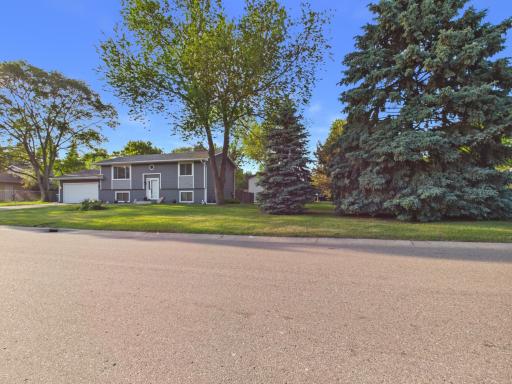 Large corner lot with mature trees and fenced backyard.