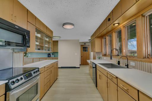 Open kitchen layout flows seamlessly into dining and living areas.