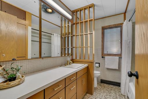 Shared full bathroom with large vanity for easy morning routines.