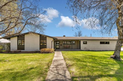 Welcome Home! Fresh paint, green grass and adorned front porch feels like spring.