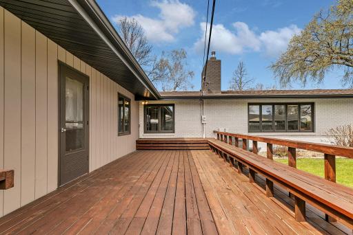 Expansive back deck overlooking the backyard. Benched seating adorns the 24 x 13 deck.