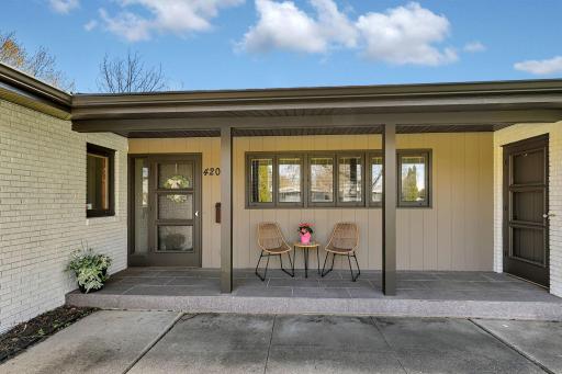 Covered front porch to enjoy a morning coffee. Appreciate the granite tiling.
