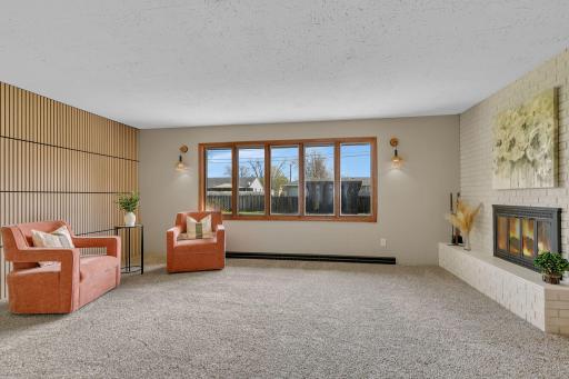 Bright front living room provides a great first impression of the home. Fireplace is gorgeous, and the fenced in yard is beautiful.