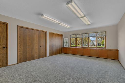 Large primary bedroom, ready for your personal touches. This room with tons of closet and storage was used previously as an art studio. Don't need 4 bedrooms? Room could be a den or office.