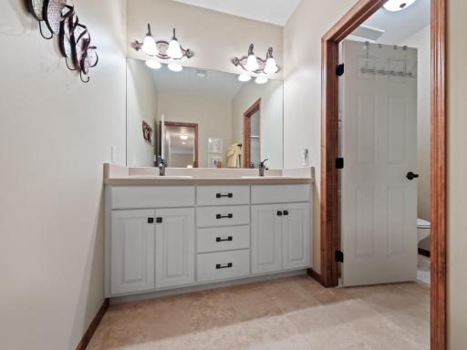 Crisp white vanity with dual sinks, plenty of storage space and several on-trend finishes.
