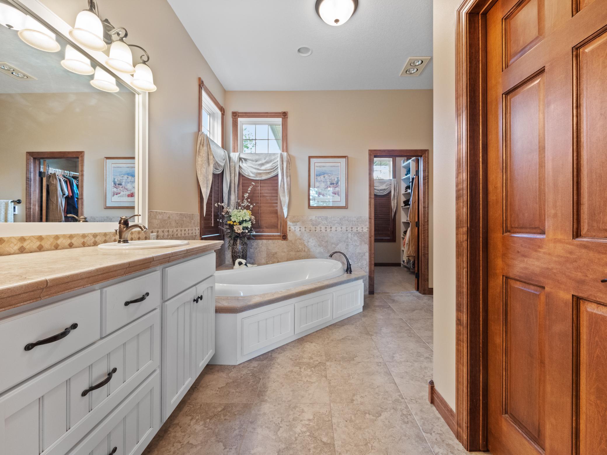 Another stunning space with heated tiled floors, dual sinks, a jetted tub and separate walk-in shower.
