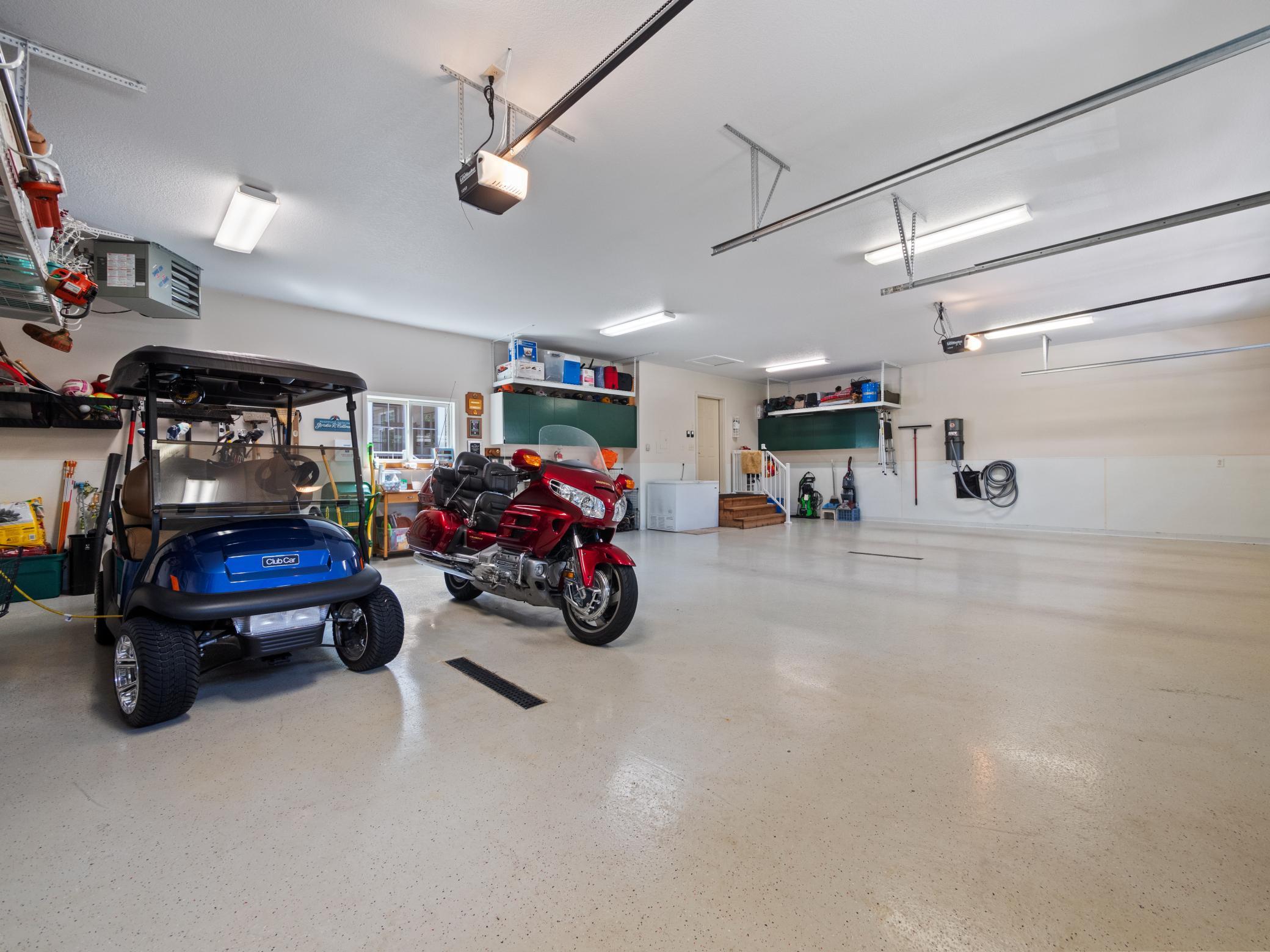 A sleek and durable epoxy-coated garage floor gives this space a seamless finish.