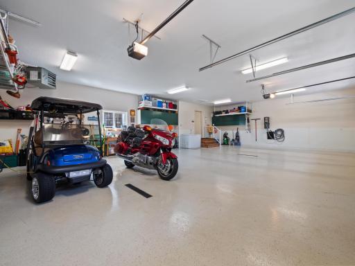 A sleek and durable epoxy-coated garage floor gives this space a seamless finish.