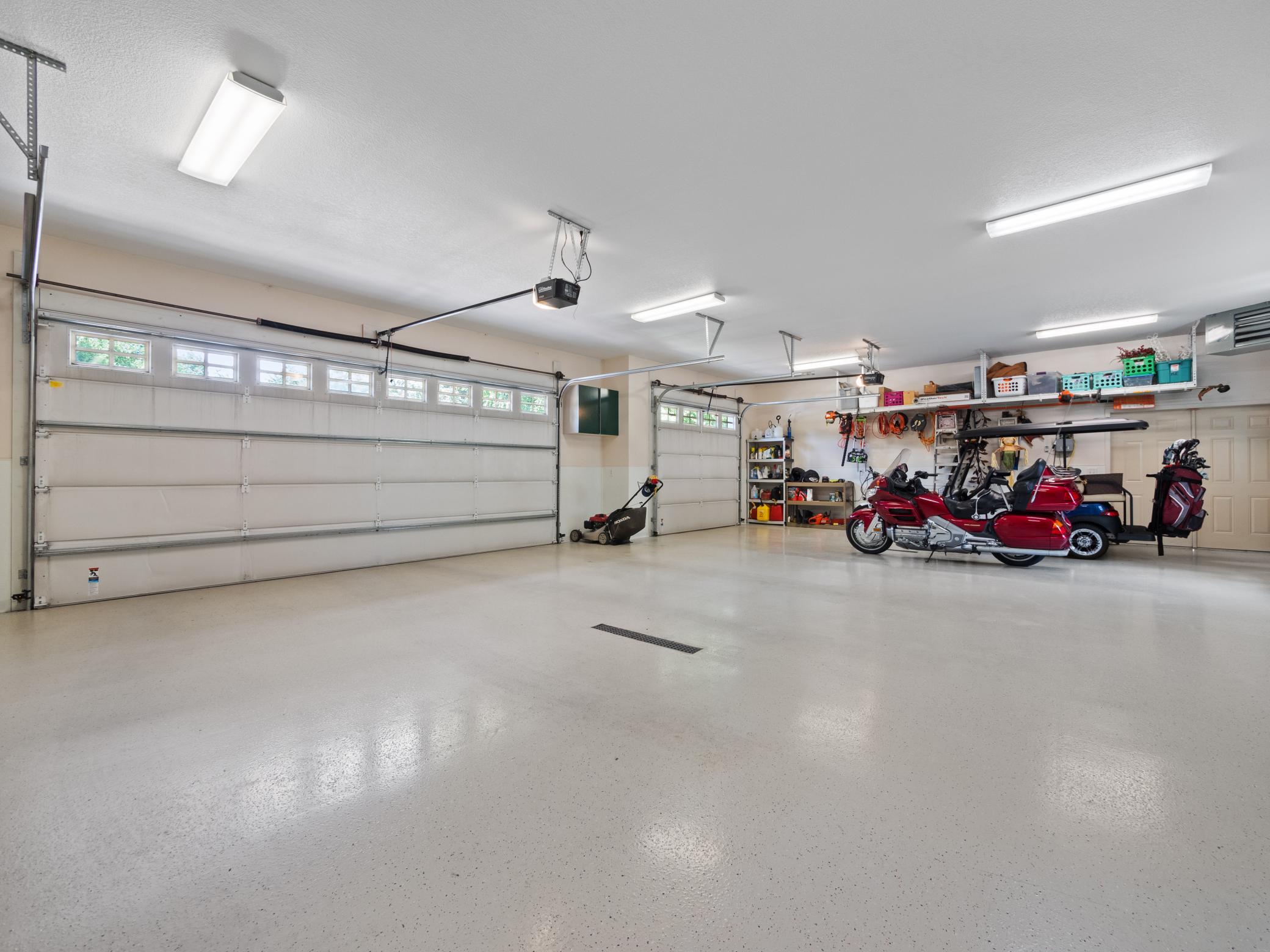 Expansive 3 car garage has new racks and cabinets!
