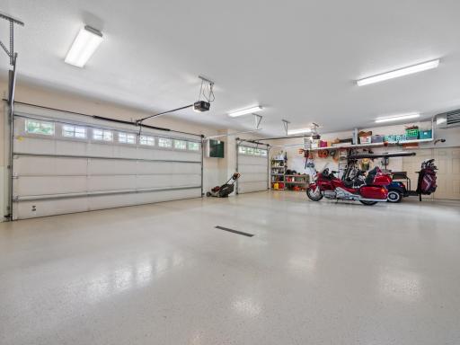 Expansive 3 car garage has new racks and cabinets!