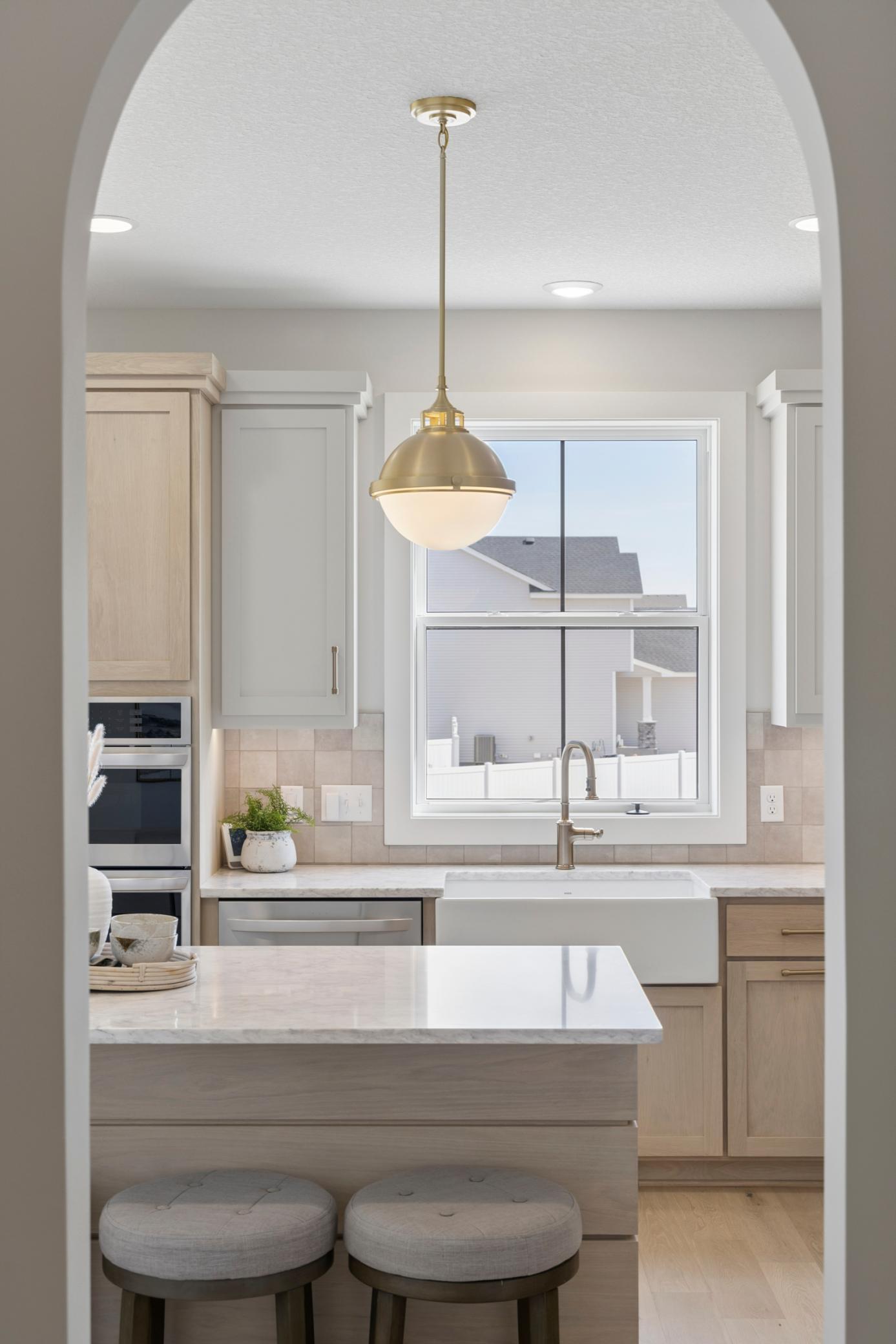 Arched opening between kitchen and mudroom.