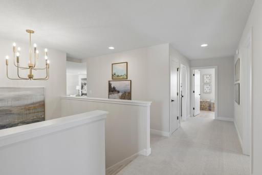 Large landing at top of stairs to upper level with gorgeous hanging light fixture.