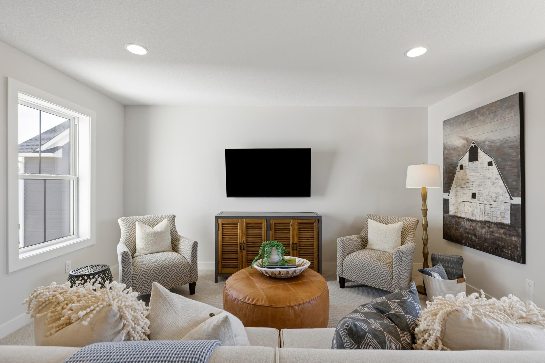 Bonus room features windows on both the front and back of home.