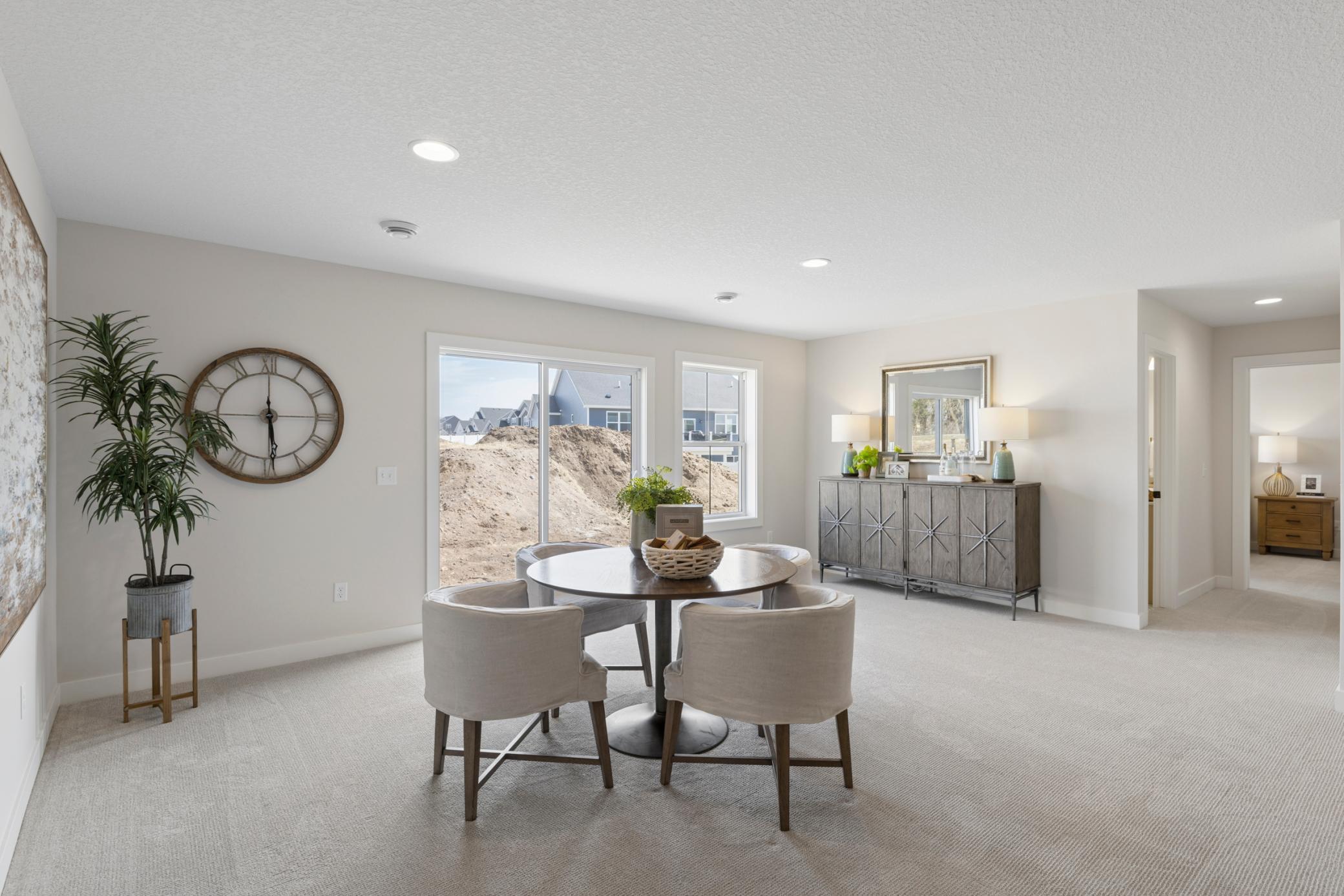Walkout sliding glass door and window provides abundant light to lower level family room.