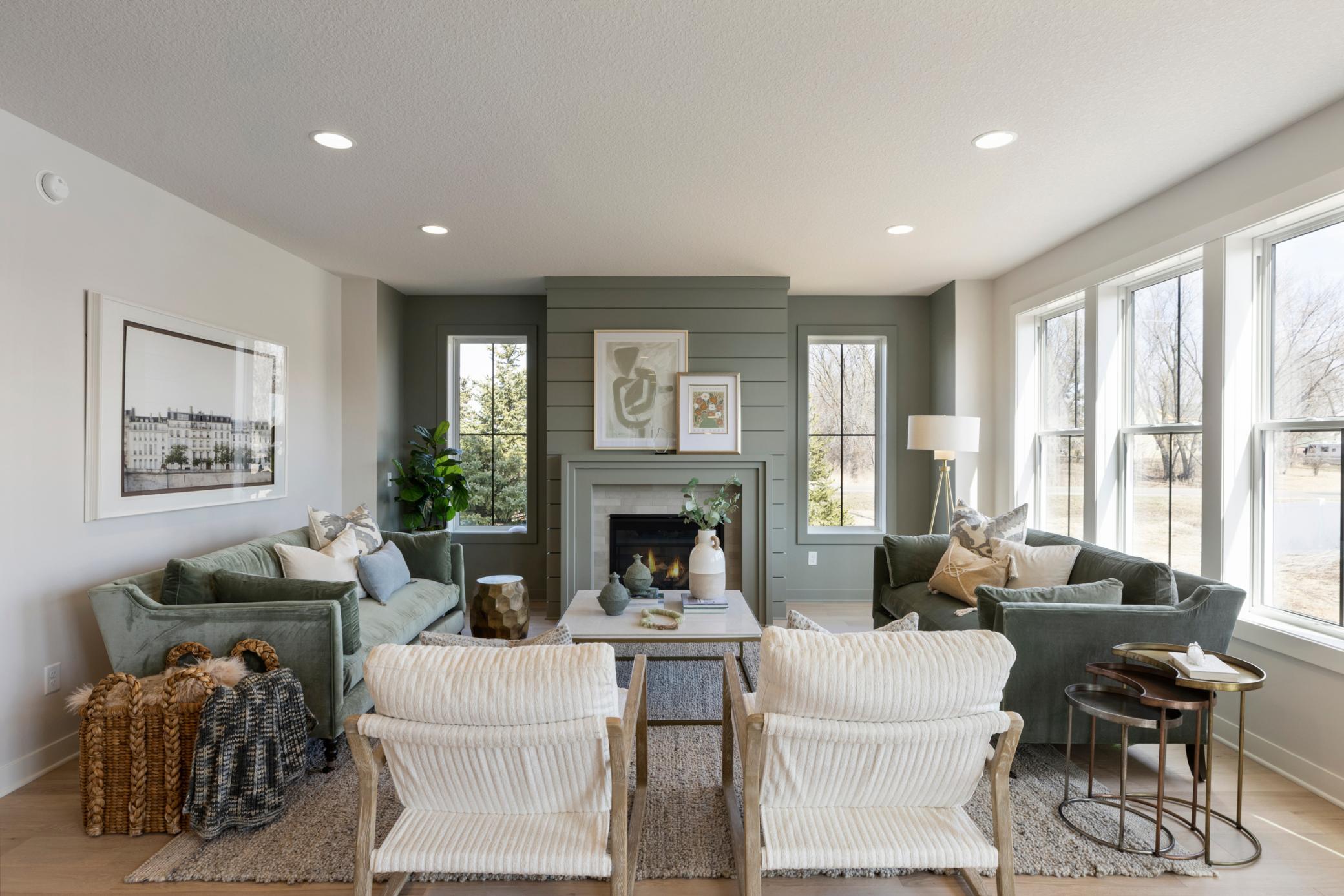 Spacious main floor gathering room features color-drenched fireplace wall.