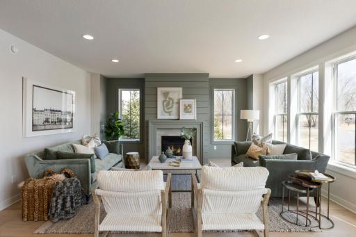 Spacious main floor gathering room features color-drenched fireplace wall.