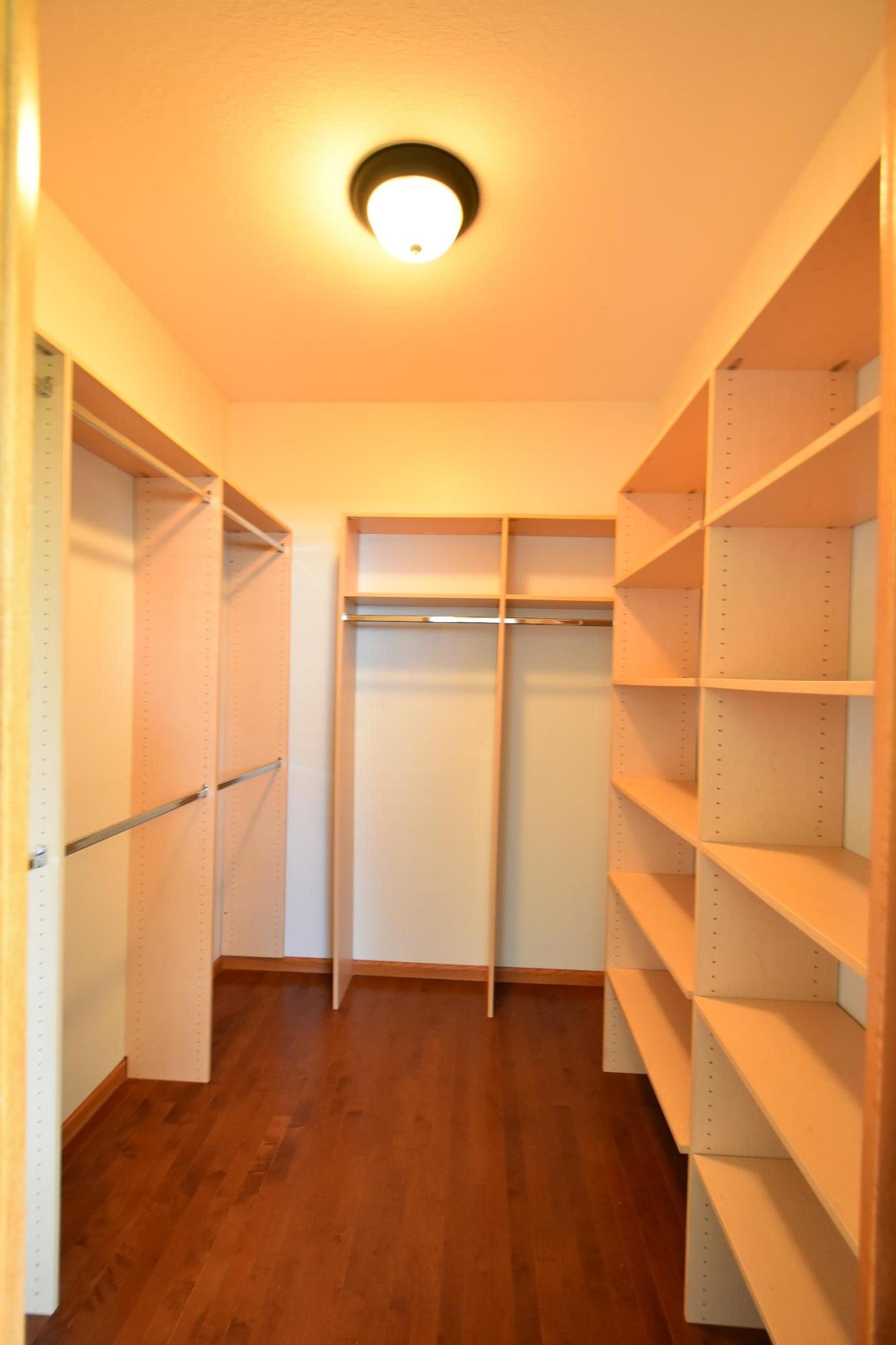 Large walk-in clostet with custom shelving