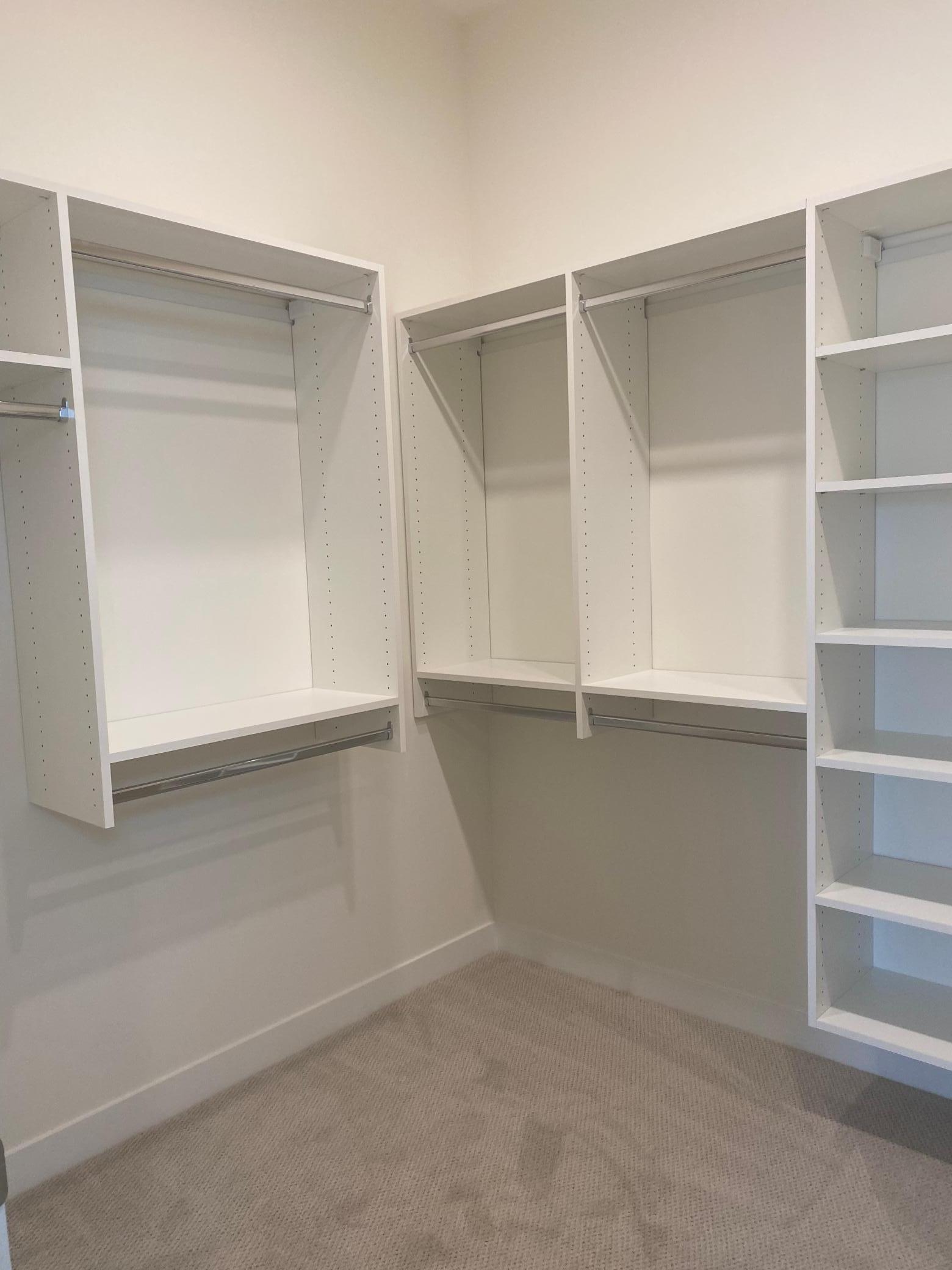 The spacious walk-in closet is enhanced with custom built-ins, providing tailored storage solutions for clothing, shoes, and accessories. Thoughtfully designed for organization and style!