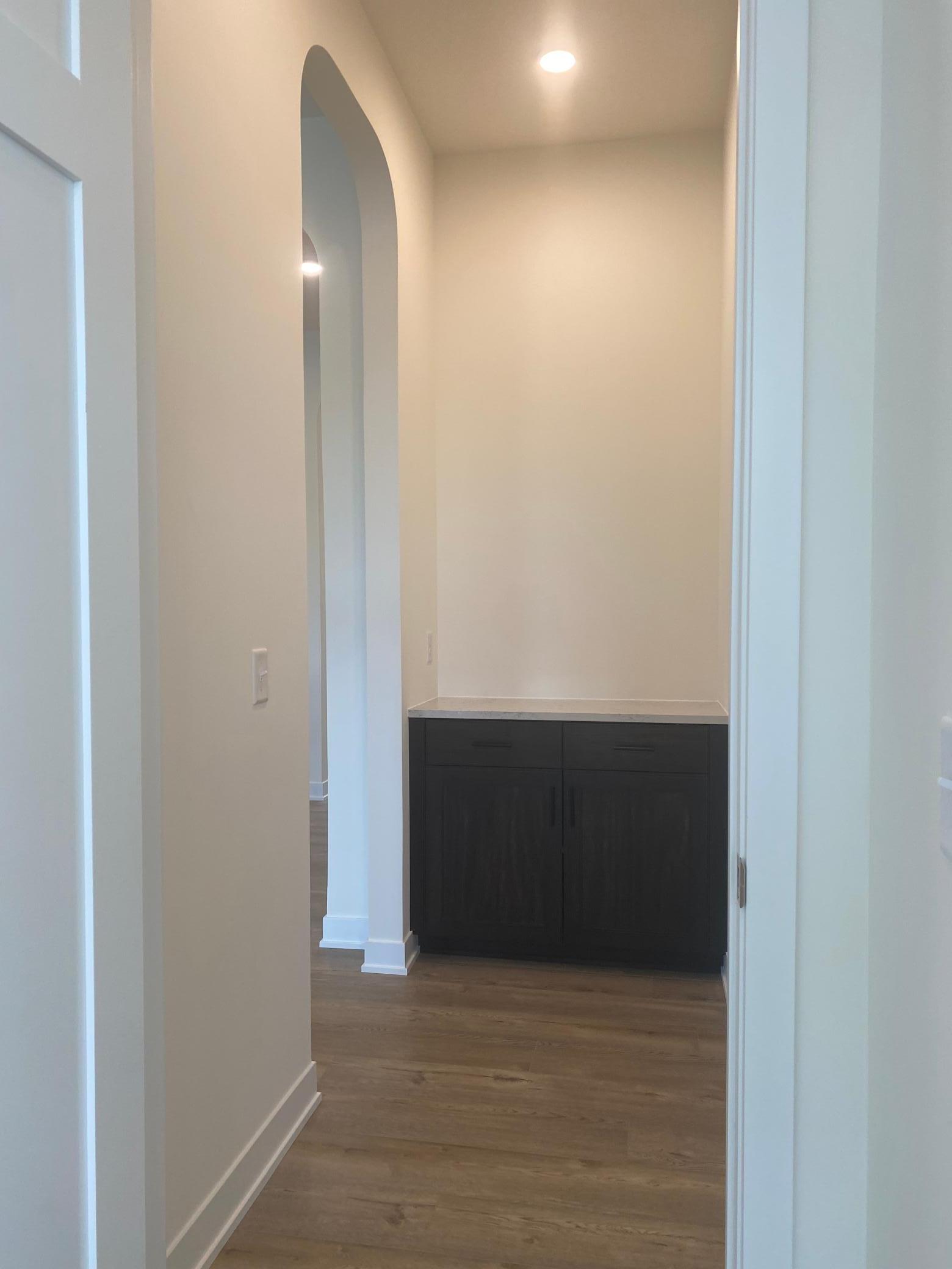 Custom entrance to the primary bedroom with built-ins adds style and thoughtful luxury.