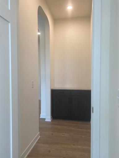 Custom entrance to the primary bedroom with built-ins adds style and thoughtful luxury.