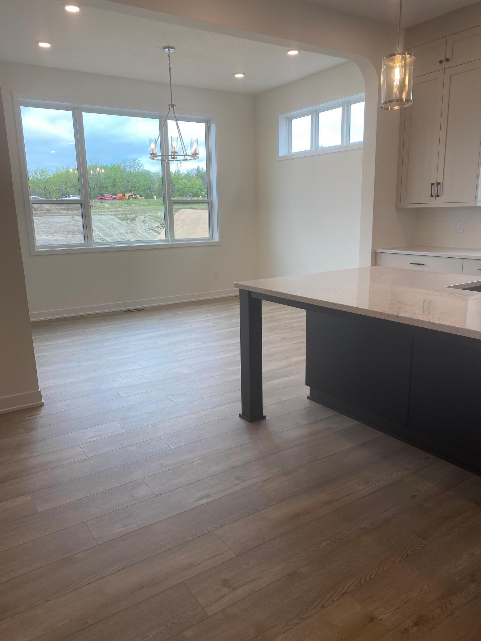 Spacious dinette with large windows and direct access to your private covered deck—perfect for enjoying serene water views.