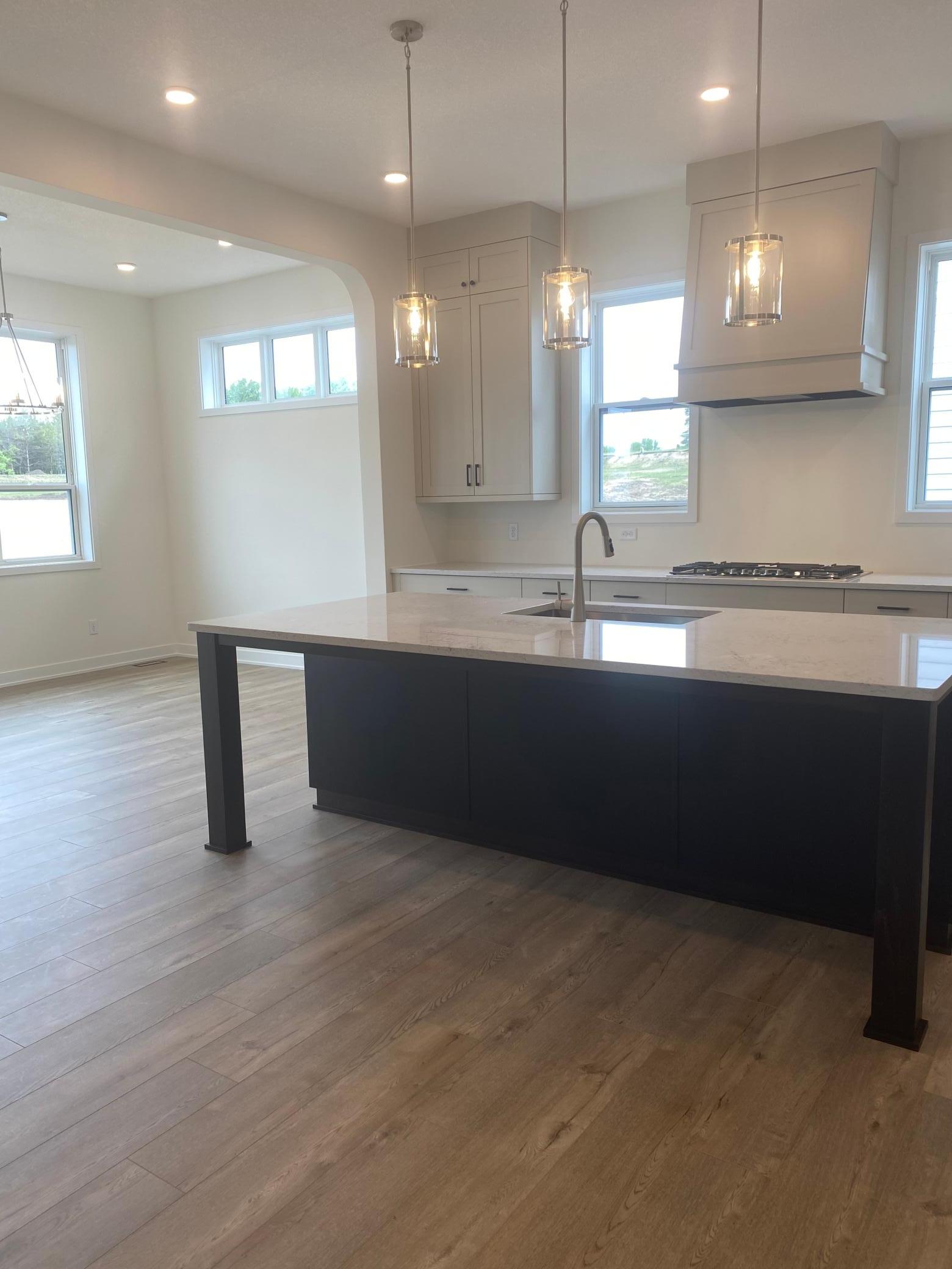 Close-up of the oversized quartz island with 3 cm countertops, undermount sink, and stylish furniture-style legs—functional beauty at its finest.