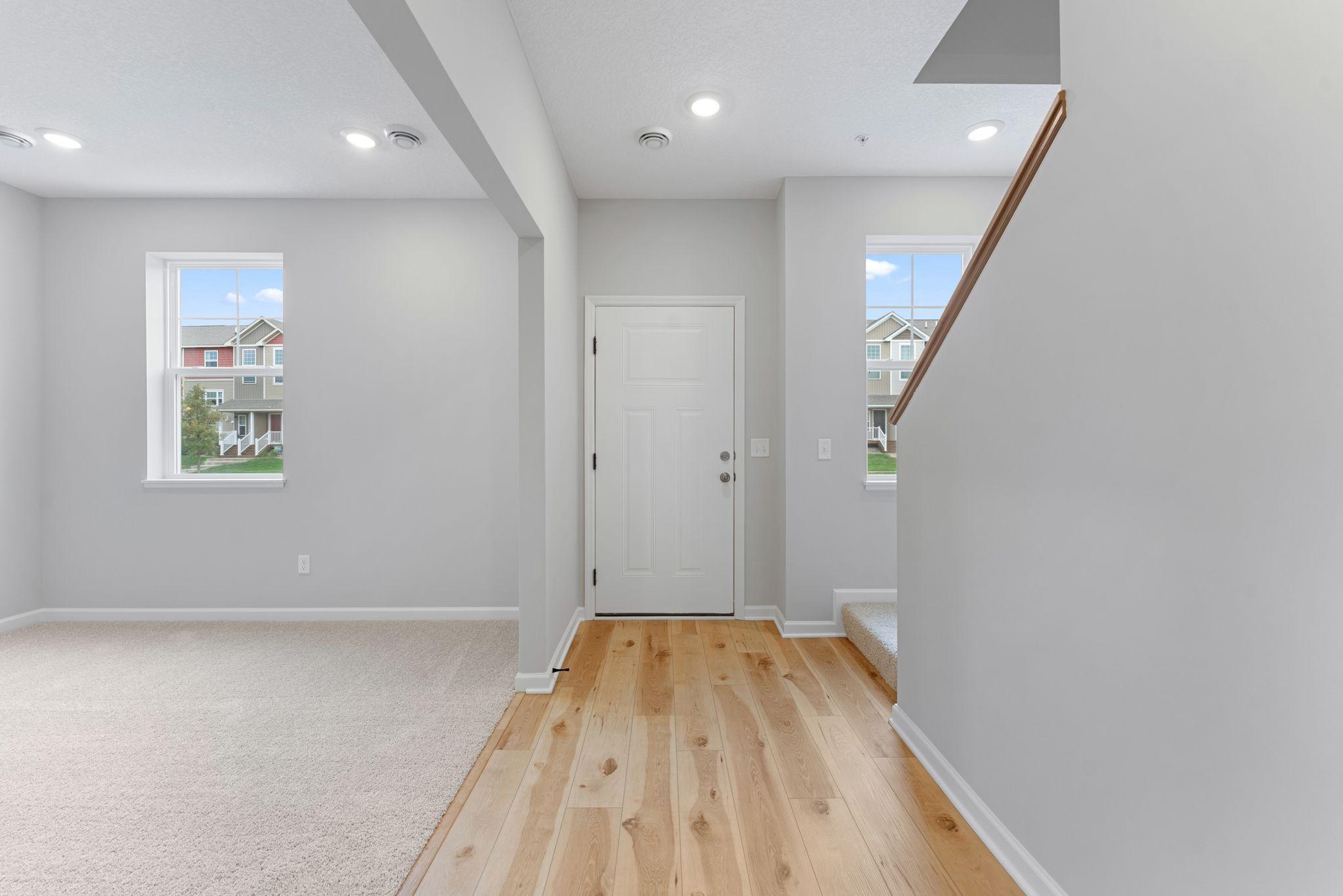 Entry way leads to the adjacent rec room or continue up to the main level. Similar home shown, options can vary.