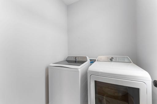 The laundry room includes the washer and dryer.
