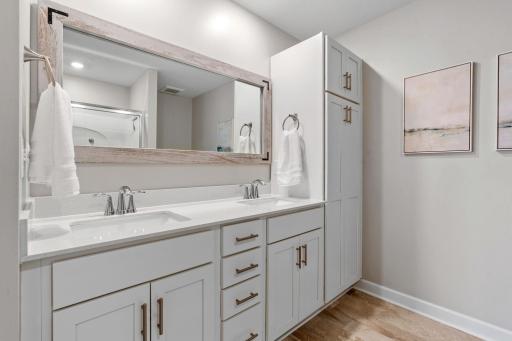 Spacious Primary Suite w/ double door entry, oversized shower, quartz counters + large walk-in closet