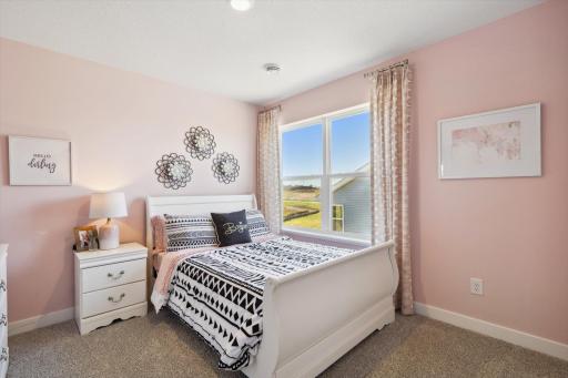 In addition to the primary bedroom, the home's upper level also includes these three additional bedrooms, and another full bathroom just adjacent to each! Photo of model, colors & options will vary.