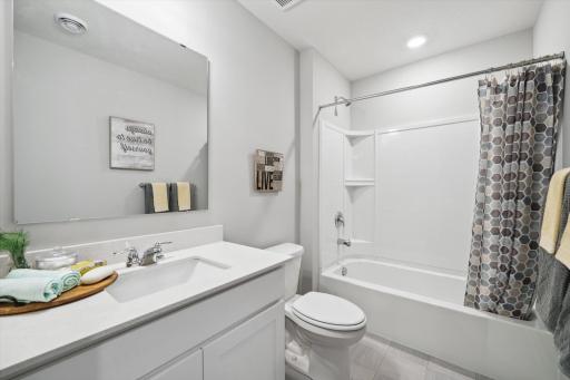 Convenience for the kids too, as the home's upper level guest bathroom features an extra long vanity and linen cabinet. Photo of model, colors & options will vary.