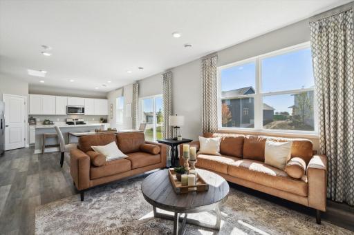 The view from this point helps re-define the open concept floor plan theory! Soaked in natural light, the family room is another spectacular use of space and offers incredible views out the back. Photo of model, colors & options will vary.
