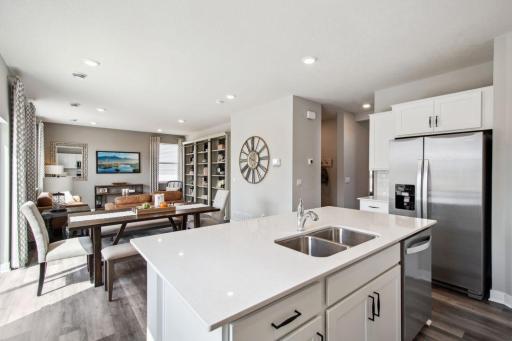Stunning in every direction, the kitchen is also remarkably functional - leaving plenty of space for the family chef to maneuver and prepare that next meal. Photo of model, colors & options will vary.