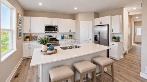 Conveniently located in the corner of the kitchen is a walk-in pantry, providing plenty of storage space! White Kitchen - Staged Photo