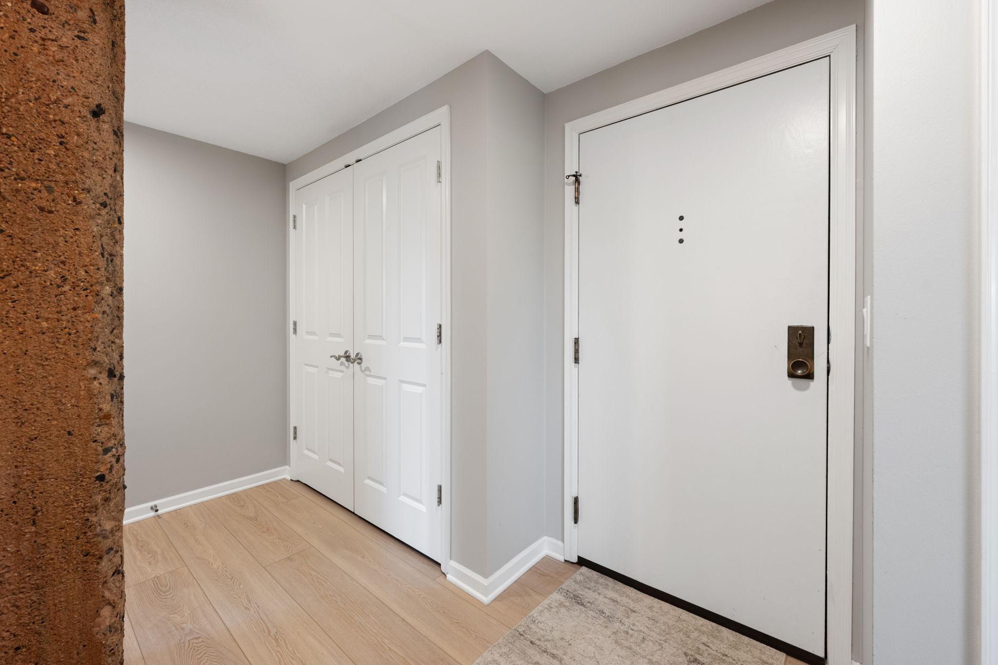 Welcoming entry with updated flooring, neutral walls, large closet space, and convenient access into the main living areas.