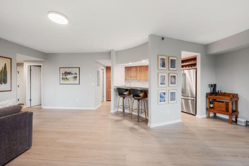 Expansive open layout with updated flooring, neutral paint, abundant wall space, and excellent flow between living, dining, and kitchen areas.