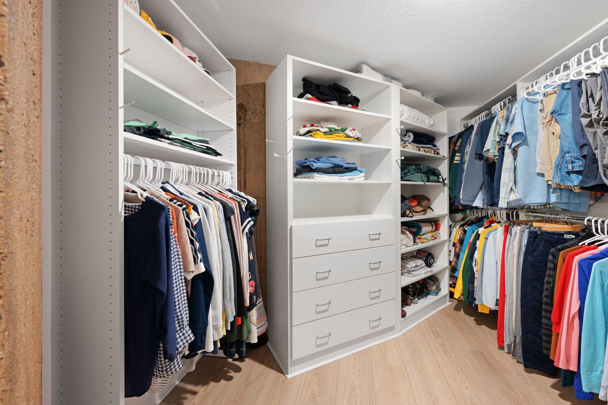 Impressive custom closet system featuring abundant shelving, drawer storage, hanging rods, and dedicated shoe storage.