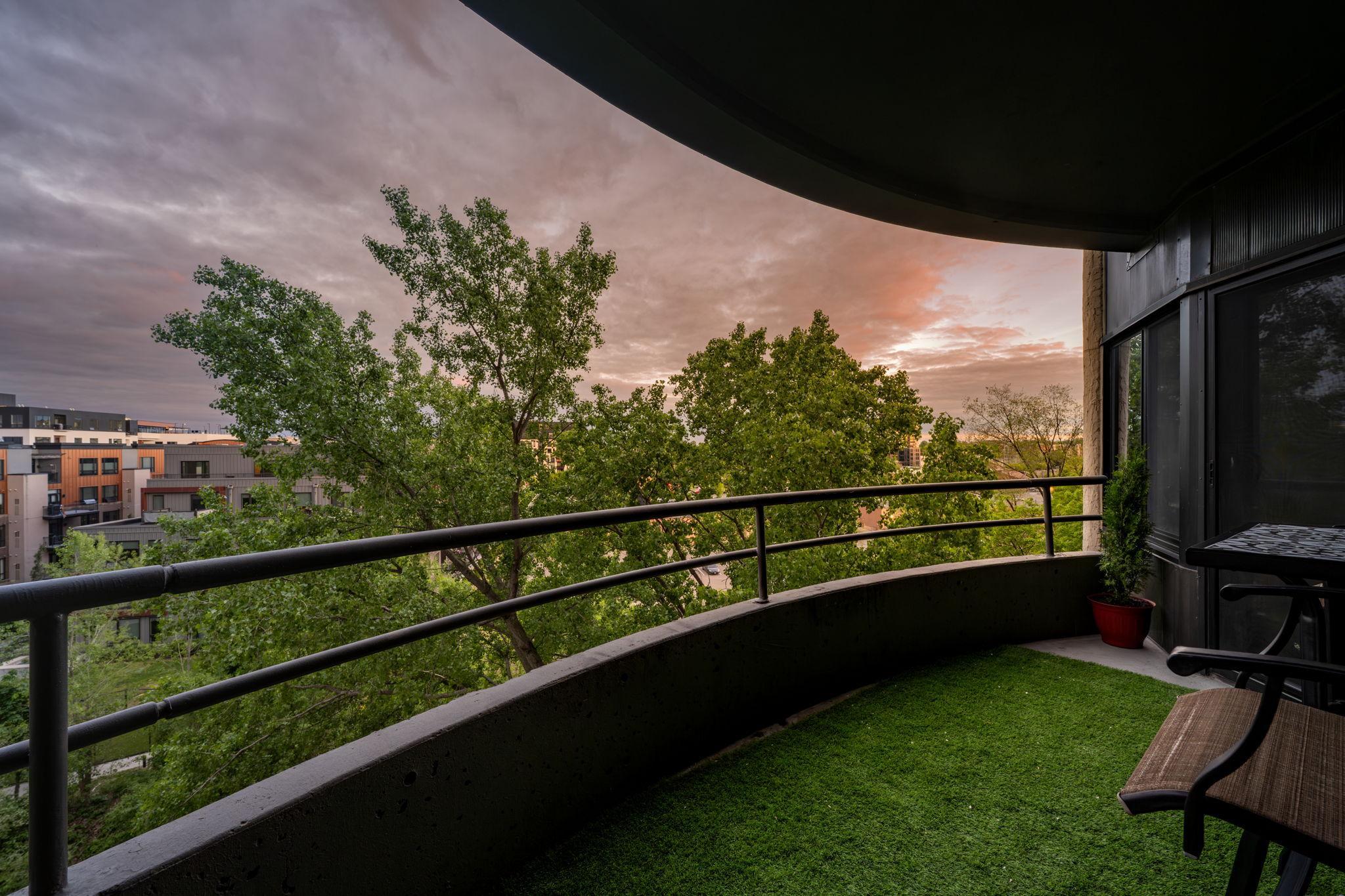 Private covered balcony with room for seating, treetop views, and a peaceful outdoor extension of the living space.